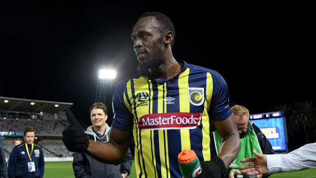 Thumbs up: Usain Bolt gestures to the crowd as he leaves the field following his debut for the Mariners.