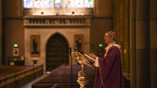 Melbourne Archbishop Peter Comensoli prepares to give the homily at Sunday mass to empty pews at St Patrick's Cathedral.