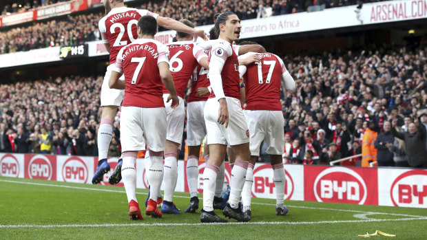 Disaster: Arsenal celebrate Pierre-Emerick Aubameyang's first goal in the win over Tottenham as a banana skin lies on the Emirates Stadium pitch.