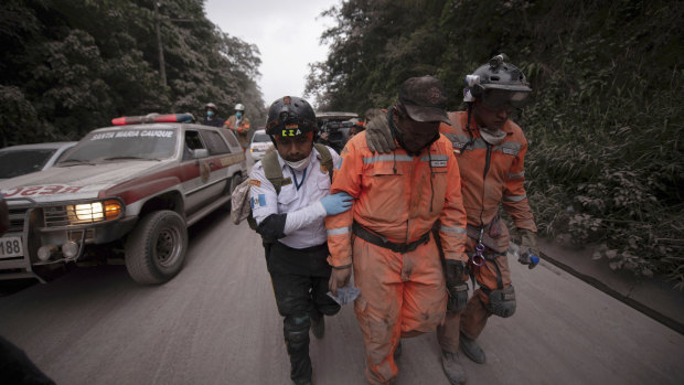 Firefighters and rescue workers leave the Volcano de Fuego evacuation area.