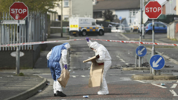 Police forensic officers at the scene in Londonderry, Northern Ireland.