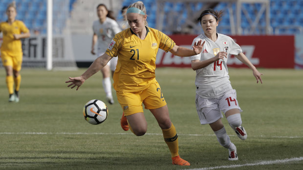 Australia's Elie Carpenter takes on Japan's Hasegawa Yui during the Women's Asian Cup in Amman, Jordan.