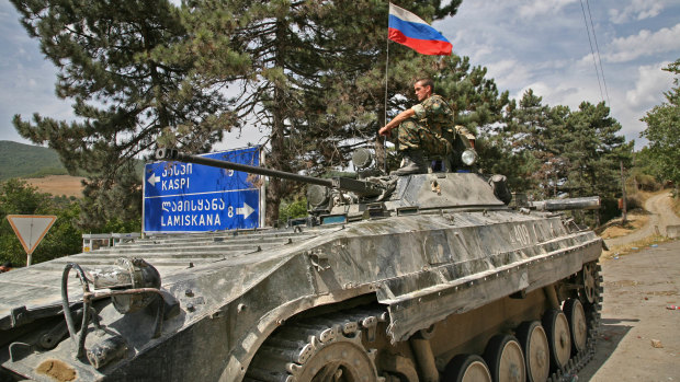 A Russian soldier sitting on a tank in the Georgian town of Igoeti in 2008.