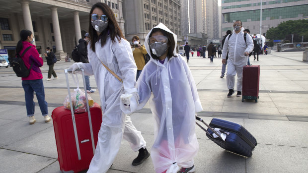 Travellers at Wuhan's main train station on Wednesday, the day the lockdown was partially lifted. Beijing will not countenance any criticism of how it managed the virus outbreak.