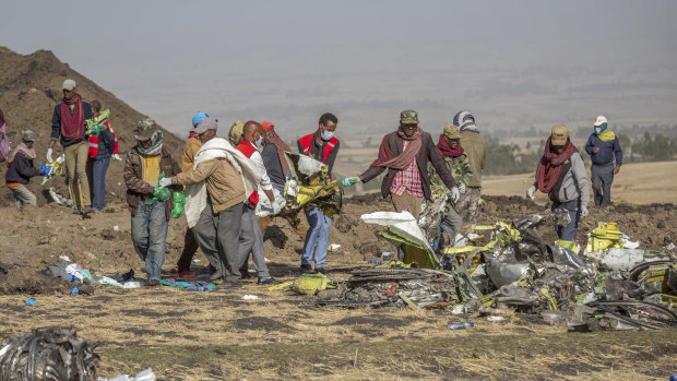Red Cross workers combing the scene of the Ethiopian Airlines crash for evidence and personal belongings outside Addis Ababa.