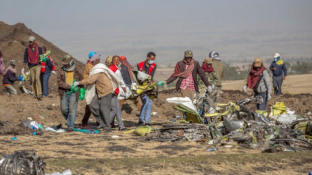 Rescuers work at the scene of the crash near Bishoftu, or Debre Zeit, south of Addis Ababa,  Ethiopia, on Monday.