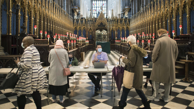 People arrive to receive their COVID-19 vaccine in Westminster Abbey, London. 