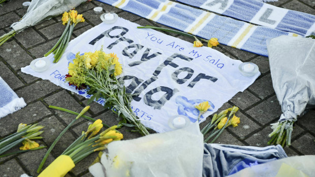 Flowers and tributes are placed outside Cardiff City Football Club in Wales.