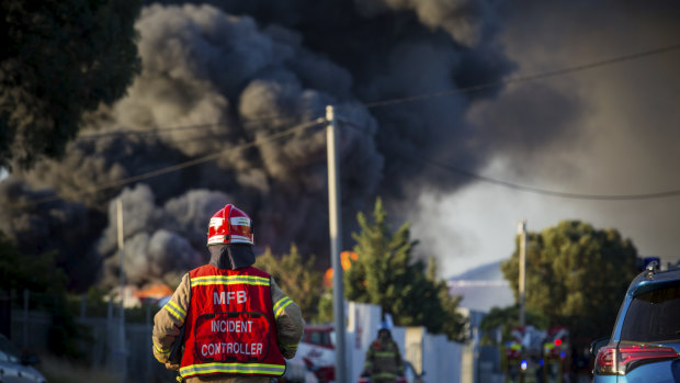 A MFB Incident Controller in front of the toxic smoke plumes.