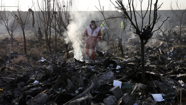 Rescue workers at the scene of the crash site near Tehran.