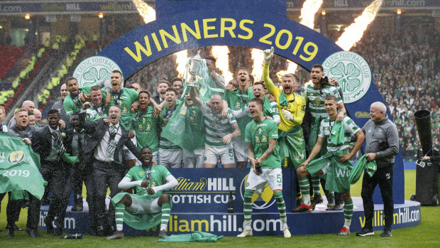 Celtic celebrate with the trophy at Hampden Park.