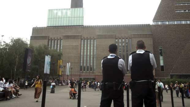 Emergency crews attending a scene at the Tate Modern art gallery, London, Sunday. London police say a teenager was arrested after a child "fell from height" at the Tate Modern art gallery. 