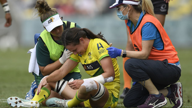 Chloe Dalton receives treatment after being injured during the Oceania Sevens. 
