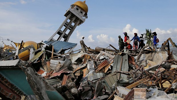 Villagers wait for any word on their missing relatives lost in the Balarola neighbourhood of Palu city.