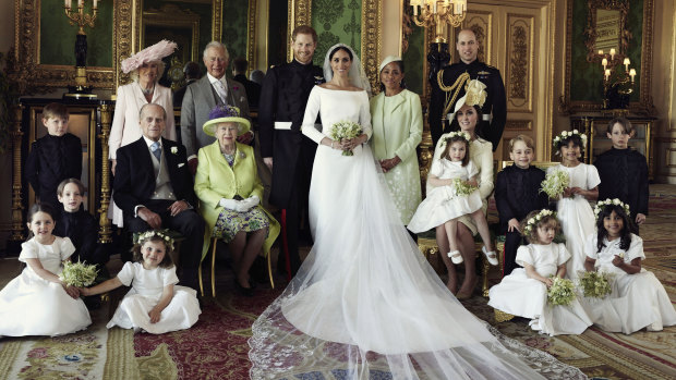 Britain's Prince Harry and Meghan Markle, centre, in Windsor Castle with (from left, back row) Jasper Dyer, Camilla, Duchess of Cornwall, Prince Charles, Doria Ragland, Prince William; (centre row) Brian Mulroney, Prince Philip, Queen Elizabeth II, Kate, Duchess of Cambridge, Princess Charlotte, Prince George, Rylan Litt, John Mulroney; (front row) Ivy Mulroney, Florence van Cutsem, Zalie Warren, Remi Litt.