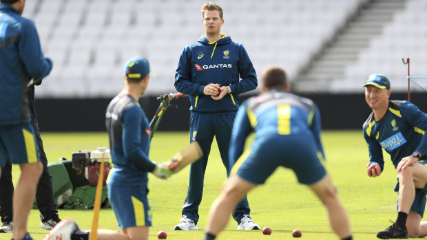 Steve Smith watches on as fielding coach Brad Haddin puts teammates through catching practice in Leeds.