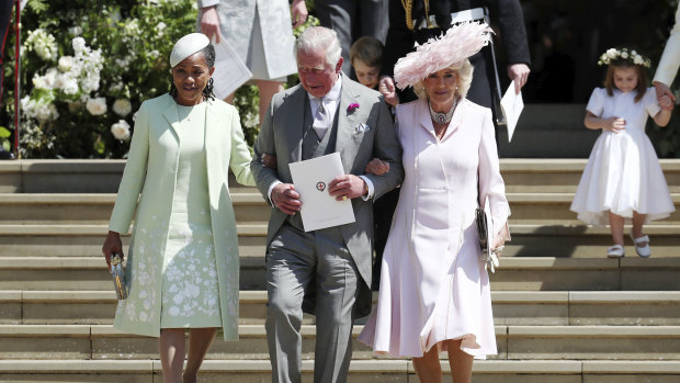 Doria Ragland, Prince Charles and Camilla, Duchess of Cornwall, walk down the steps of St George's Chapel.