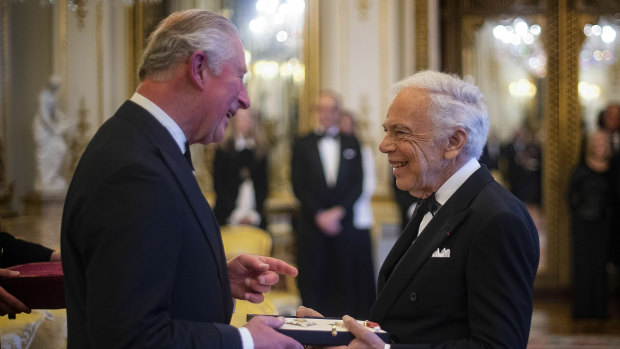 The Prince of Wales presents designer Ralph Lauren with his honorary KBE for Services to Fashion in a private ceremony at Buckingham Palace on Wednesday.