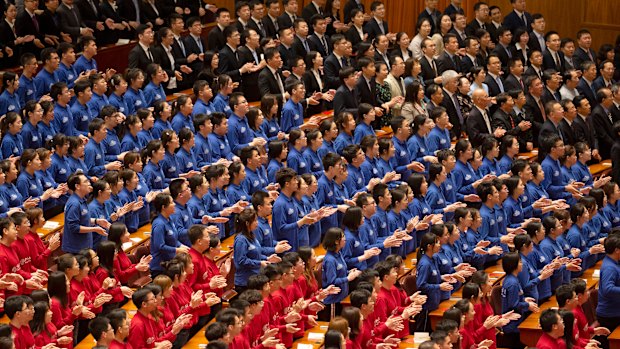 Chinese students applaud during a commemoration of the 100th anniversary of the May 4 Movement at the Great Hall of the People in Beijing on Tuesday.