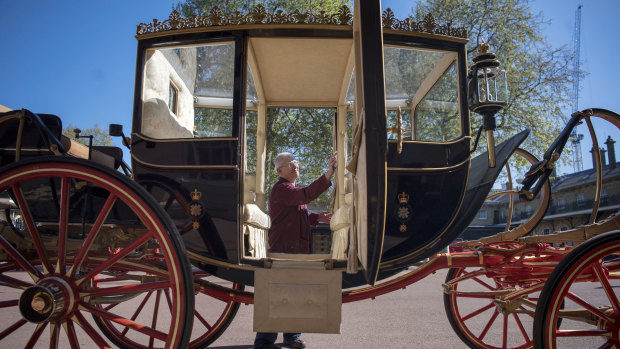 Martin Oates polishes the Scottish State Coach at the Royal Mews at Buckingham Palace. The carriage will be used if it's raining. If it's sunny, an open-top carriage will be used to transport the happy couple.