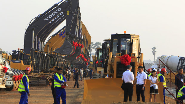 Construction machines line up during a ground-breaking ceremony to build Cambodia's first expressway.