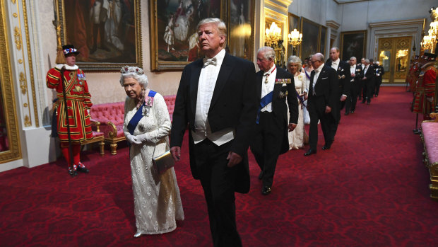 The Queent and US President Donald Trump lead guests through the East Gallery ahead of the State Banquet at Buckingham Palace in London.