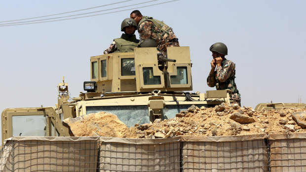 Jordanian troops patrol at the Jordanian side of Naseeb border crossing into Syria.