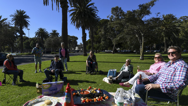 Gary and Robyn Voges, standing, catch up with a group of friends and neighbours on a stunning Autumn Day.