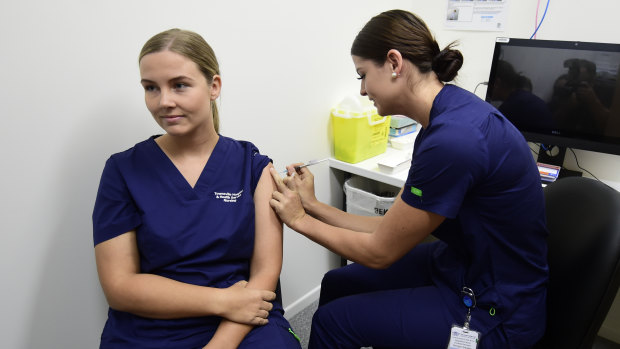 Registered nurse Rebecca DeJong receives a dose of the Pfizer COVID-19 vaccination at the Townsville University Hospital hub in March.