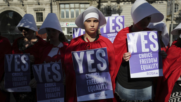 Volunteers from Reproductive rights, against Oppression, Sexism & Austerity (ROSA) dressed as characters from 'The Handmaid's Tale', demonstrate in Dublin calling for a 'Yes' vote.