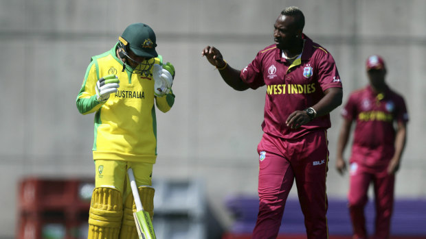 Short and sharp: West Indies' Andre Russell (right) checks on Australia's Usman Khawaja (left) after hitting him on the head with a bouncer during a World Cup warm-up match.