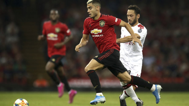 Open space: Manchester United's Andreas Pereira and AC Milan's Hakan Calhanoglu battle for the ball.
