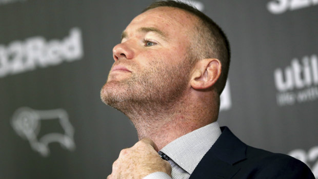 Gaffer-in-the-making: Wayne Rooney gets comfortable at the announcement of his deal with Derby at Pride Park.