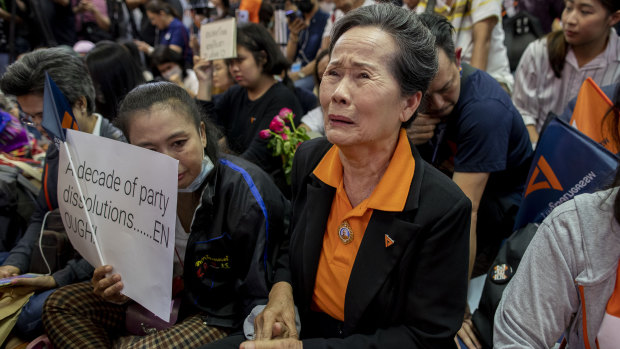 A supporter of Thailand's Future Forward Party cries as they watch a live television broadcast of a court verdict at their party's headquarters in Bangkok on Friday.