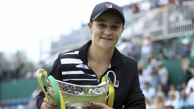 Soaring to new heights: Ash Barty poses with the trophy after beating Germany's Julia Goerges in the final of the Birmingham Classic.