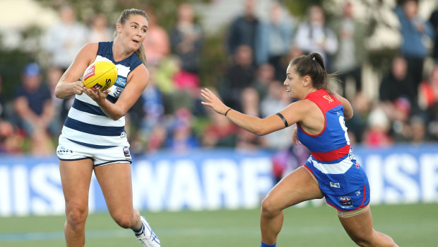 Geelong's Rebecca Webster feels the pressure from Bulldog Monique Conti.