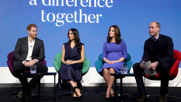 A demure Kate beside Markle, in a slinky sleeveless dress, with their husbands at a televised forum.