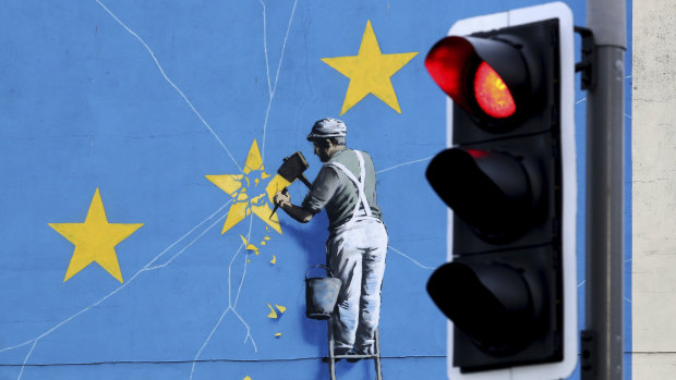A view of the Banksy Brexit mural of a man chipping away at the EU flag in Dover, England.