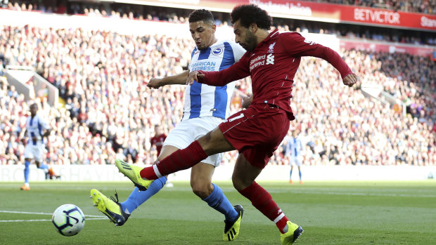 Normal service: Mohamed Salah, battling with Brighton's Steve Sidwell, scored the only goal for Liverpool.