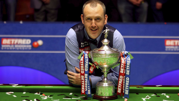 Pot luck: Mark Williams with the world championship trophy after defeating Scot John Higgins in a classic final at the Crucible.