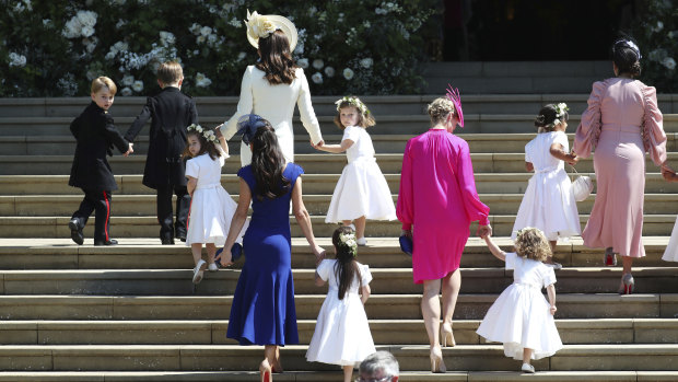 Prince George, left, Princess Charlotte, third left, Kate, the Duchess of Cambridge, background fourth left and Jessica Mulroney foreground arrive with the bridesmaids and page boys.