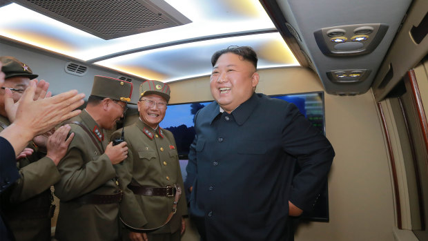 A picture provided by the North Korea government shows Kim smiling and celebrating with military officials.