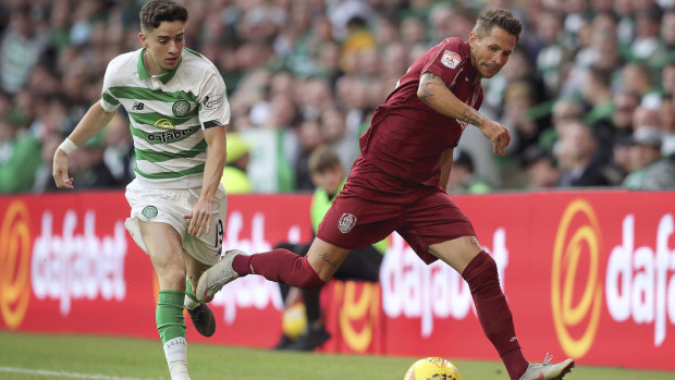 Celtic's Michael Johnston and Cluj's Ciprian Deac battle for the ball during the Champions League third qualifying round second leg match between Celtic and CFR Cluj, at Celtic Park.