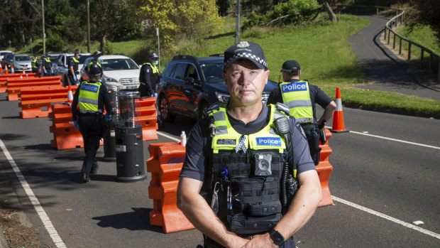 Leading Senior Constable Paul Gosling at the Upper Ferntree Gully vehicle checkpoint on Sunday, its last day of operation. 