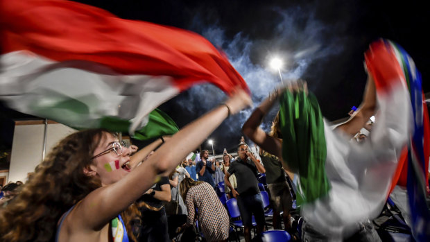 Fans celebrate in the streets of Milan after Italy beat Spain on penalties.