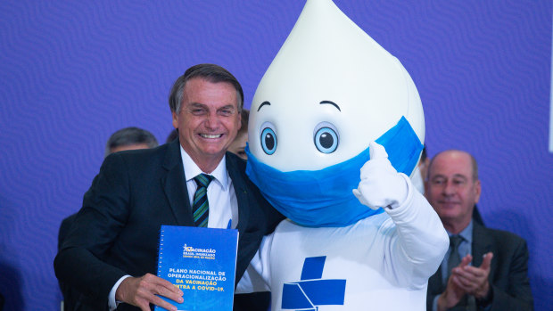 Mixed messages: Brazilian President Jair Bolsonaro who has said he won’t take a COVID-19 vaccine, poses with the mascot of his nation’s vaccination campaign, named “Ze Gotinha” or Joe Droplet.