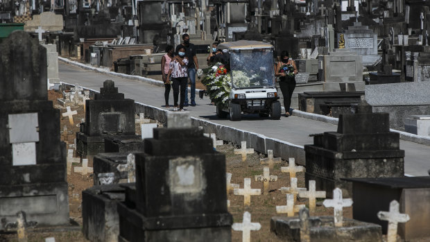 Relatives attend the burial of 71-year-old Jose Abelardo Bezerra, who died from COVID-19 related complications, in Rio de Janeiro on Thursday.
