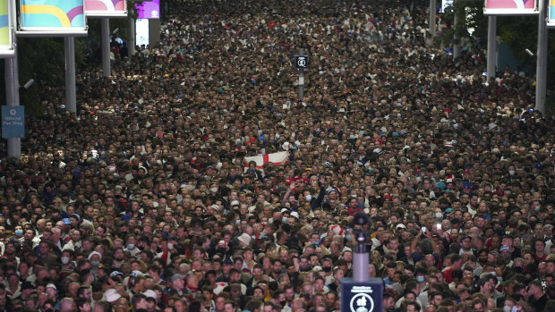Fans celebrate outside Wembley Stadium after England qualified for the Euro 2020 final.
