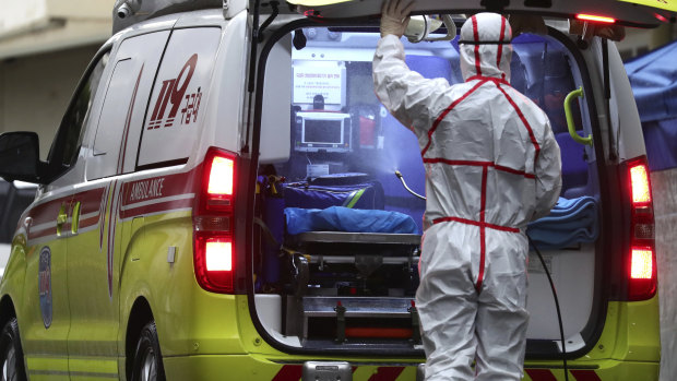 A worker wearing a protective suit sprays disinfectant in an ambulance at Dongsan Medical Centre in Daegu, South Korea.