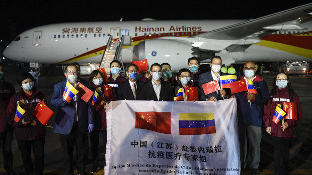 Venezuelan and Chinese officials repeat the PR exercise as a medical team arrives from China in La Guaira, Venezuela.